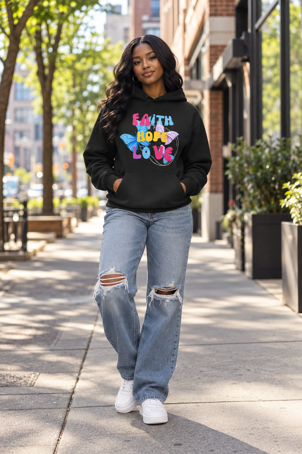 Female model wearing the Faith Hope Love Hoodie in black